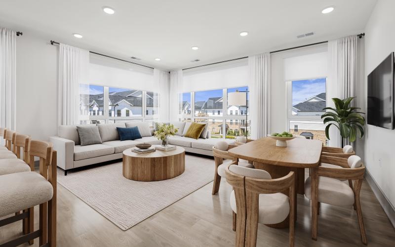 a living room with a couch, tables and chairs