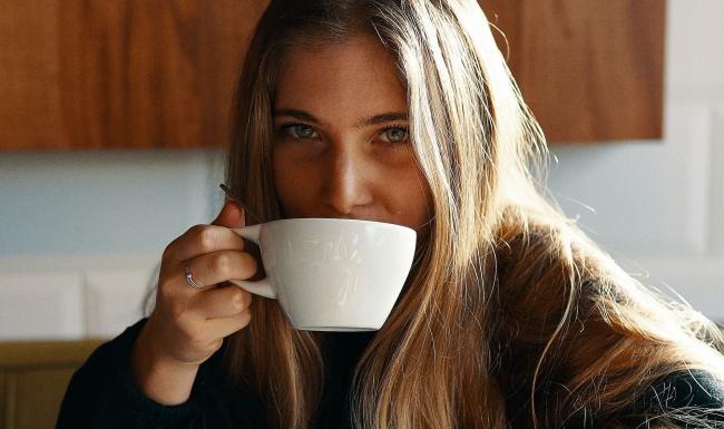 a person drinking from a cup