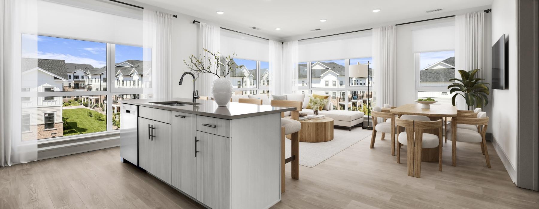 a living room and kitchen with tables and chairs