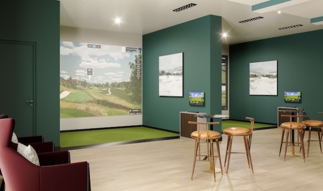 a room with golf simulators and chairs