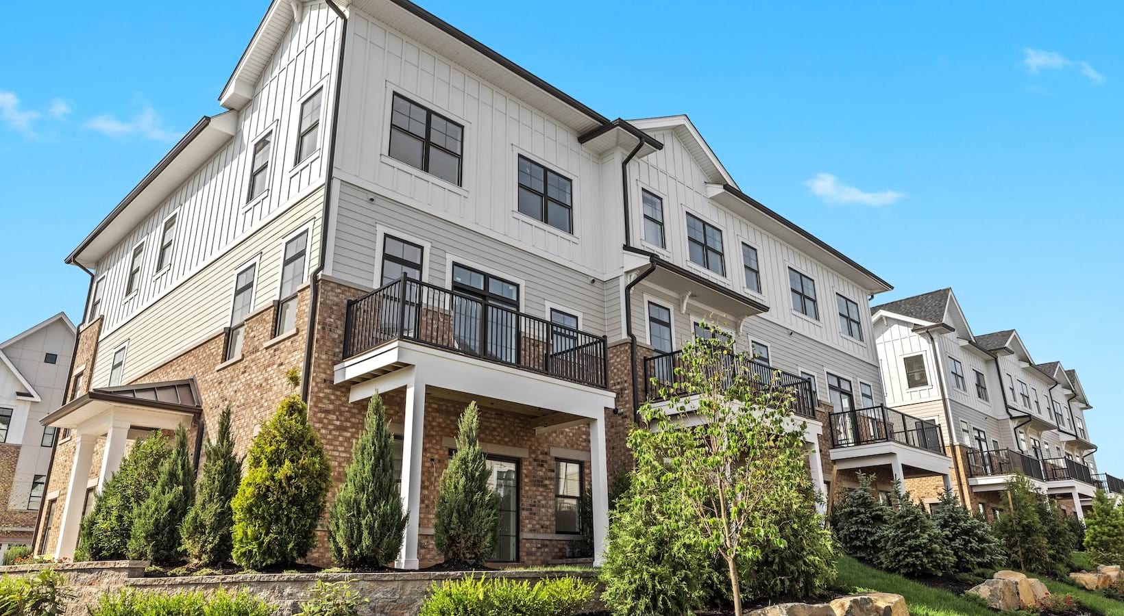 Corner image of a townhome exterior with landscaping