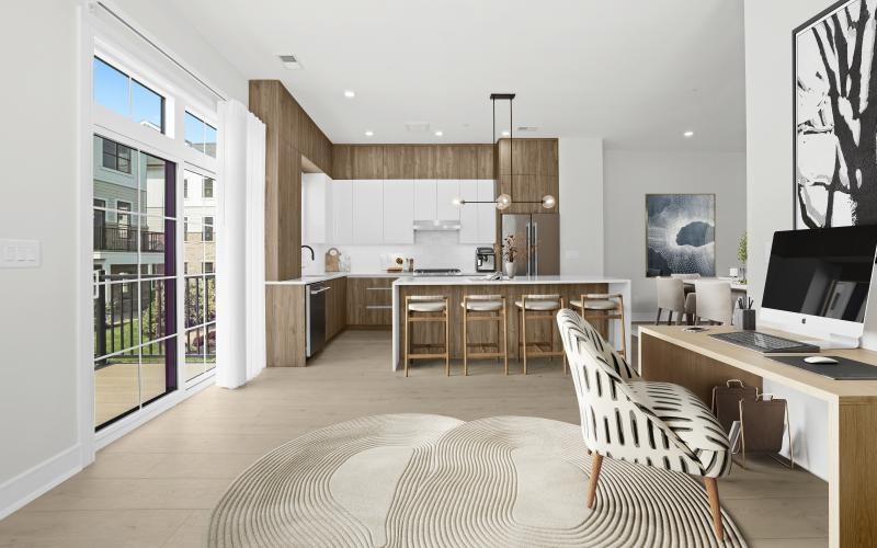 a large kitchen with an island and chairs